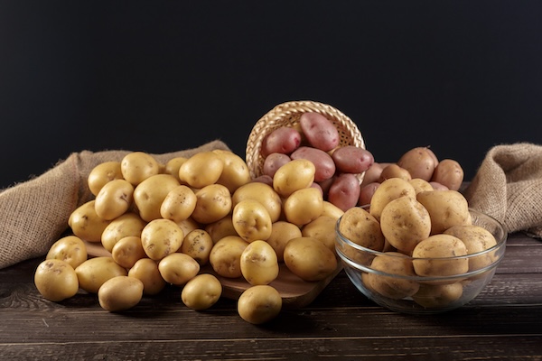 Fresh potatoes on a wood background