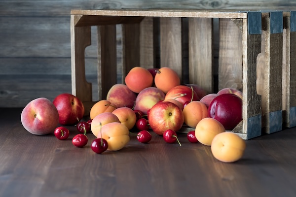 a-front-view-of-a-wooden-crate-with-stone-fruit